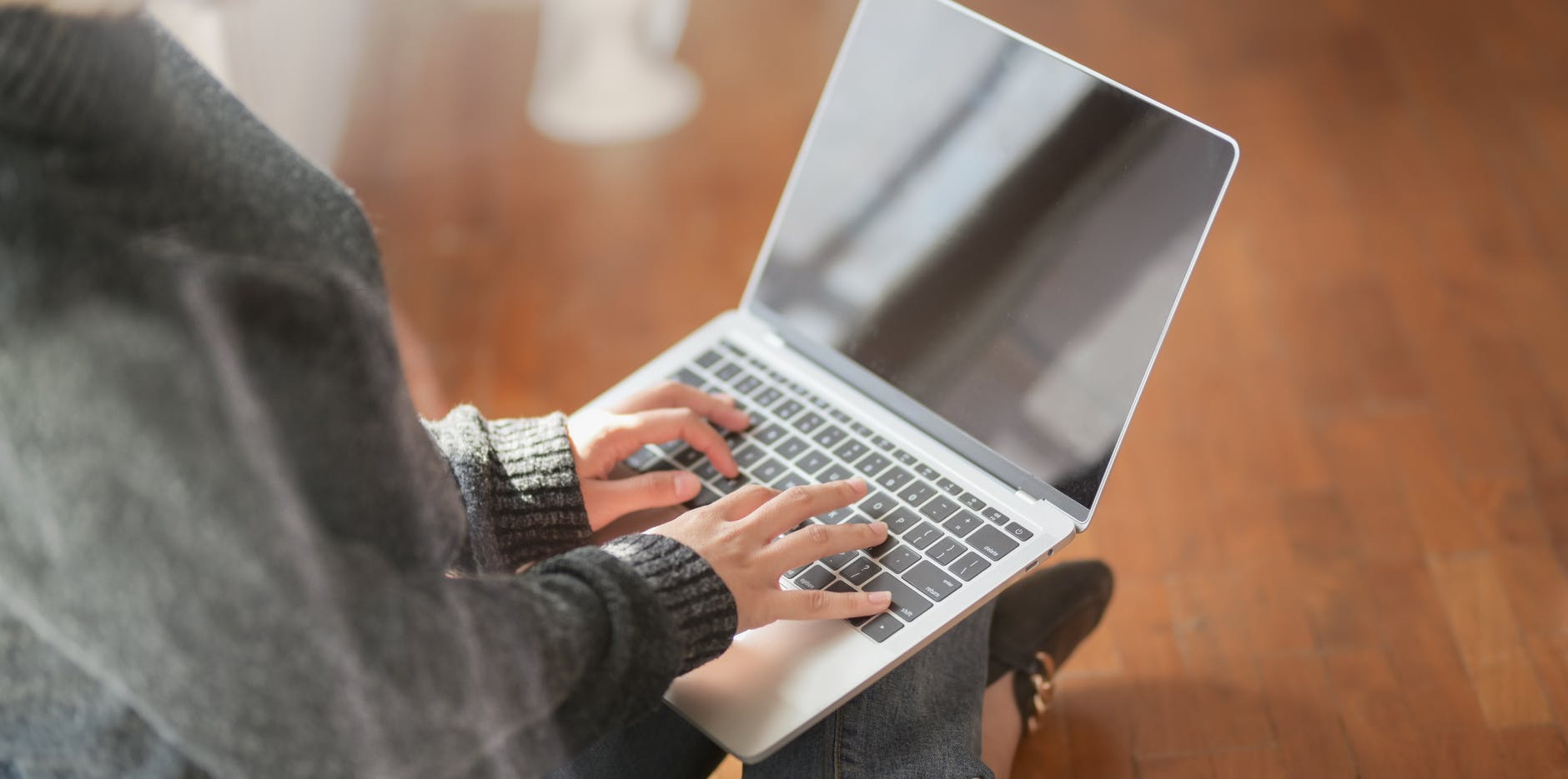 woman typing a business plan on laptop